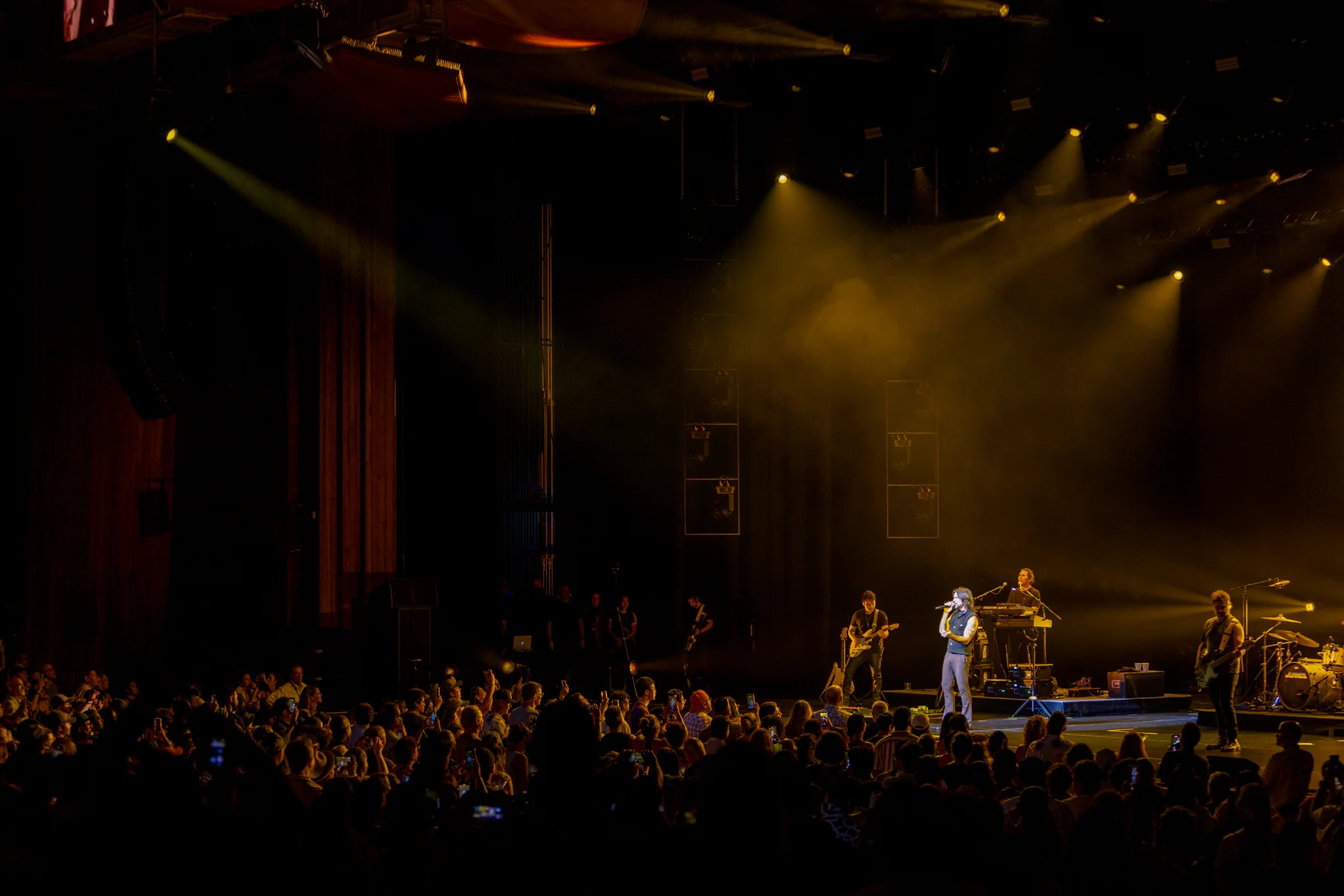 Live concert stage viewed from a large audience