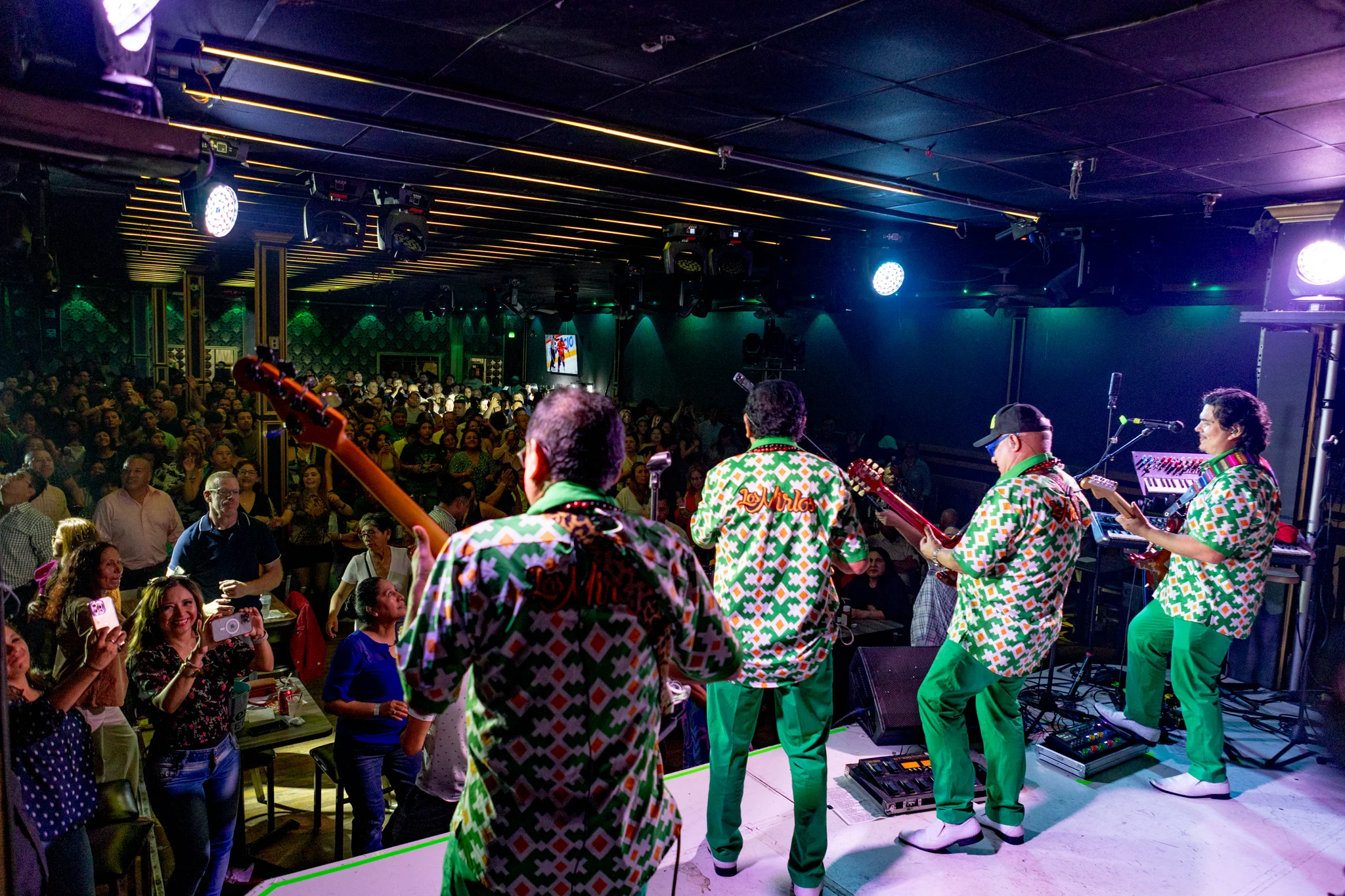 Performers on stage facing a live audience